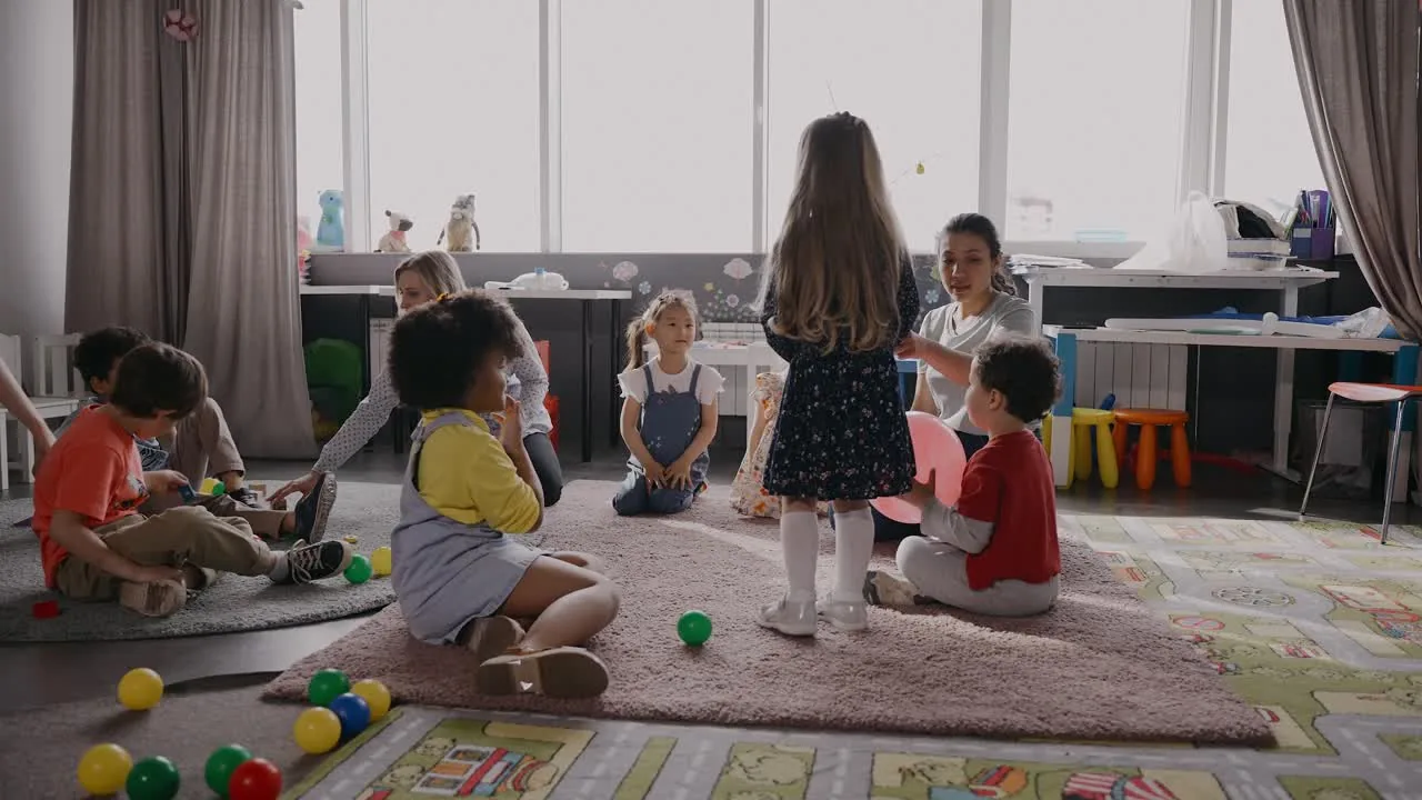Children sitting in a circle on the floor of a bright room