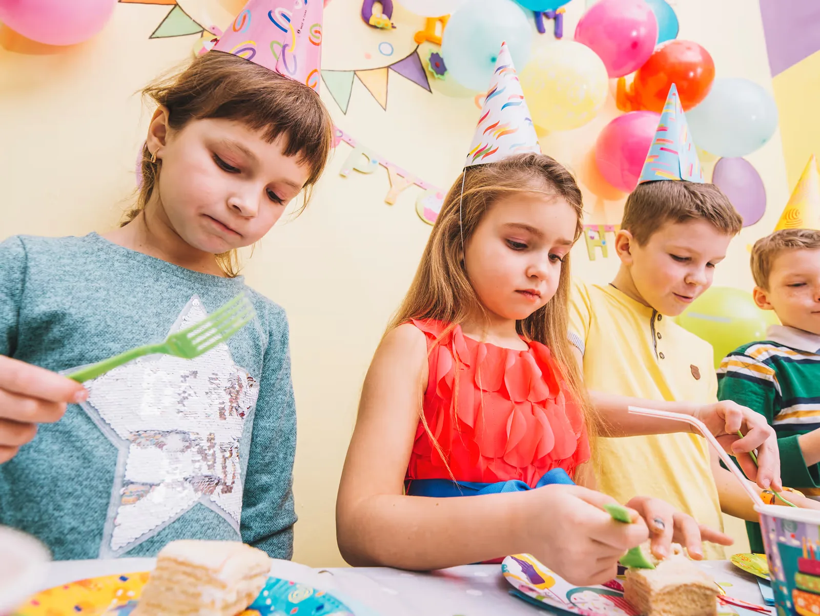 Children working together at a table covered with craft materials
