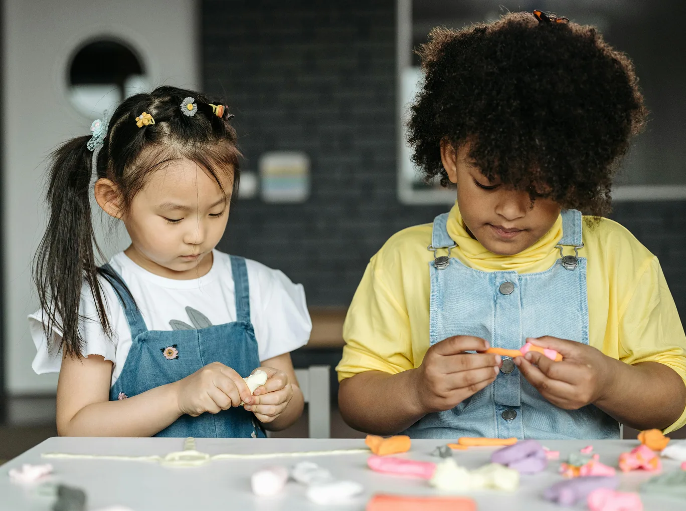 Two children working side by side on a craft activity